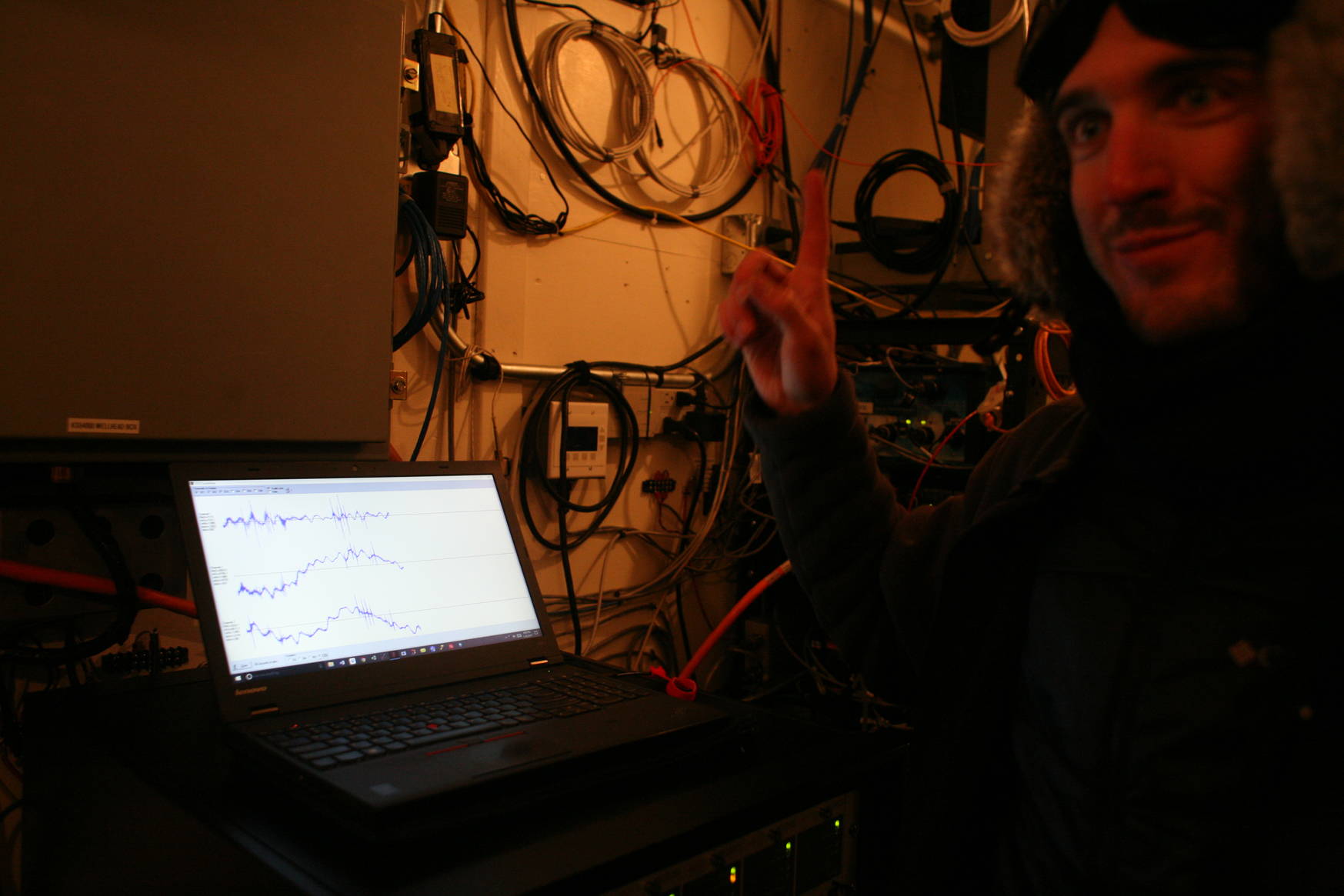 Kevin showing real-time seismological data measured from their systems. The spikes in the data correspond to me jumping and stomping around in the snow simulating a dinosaur at south pole.