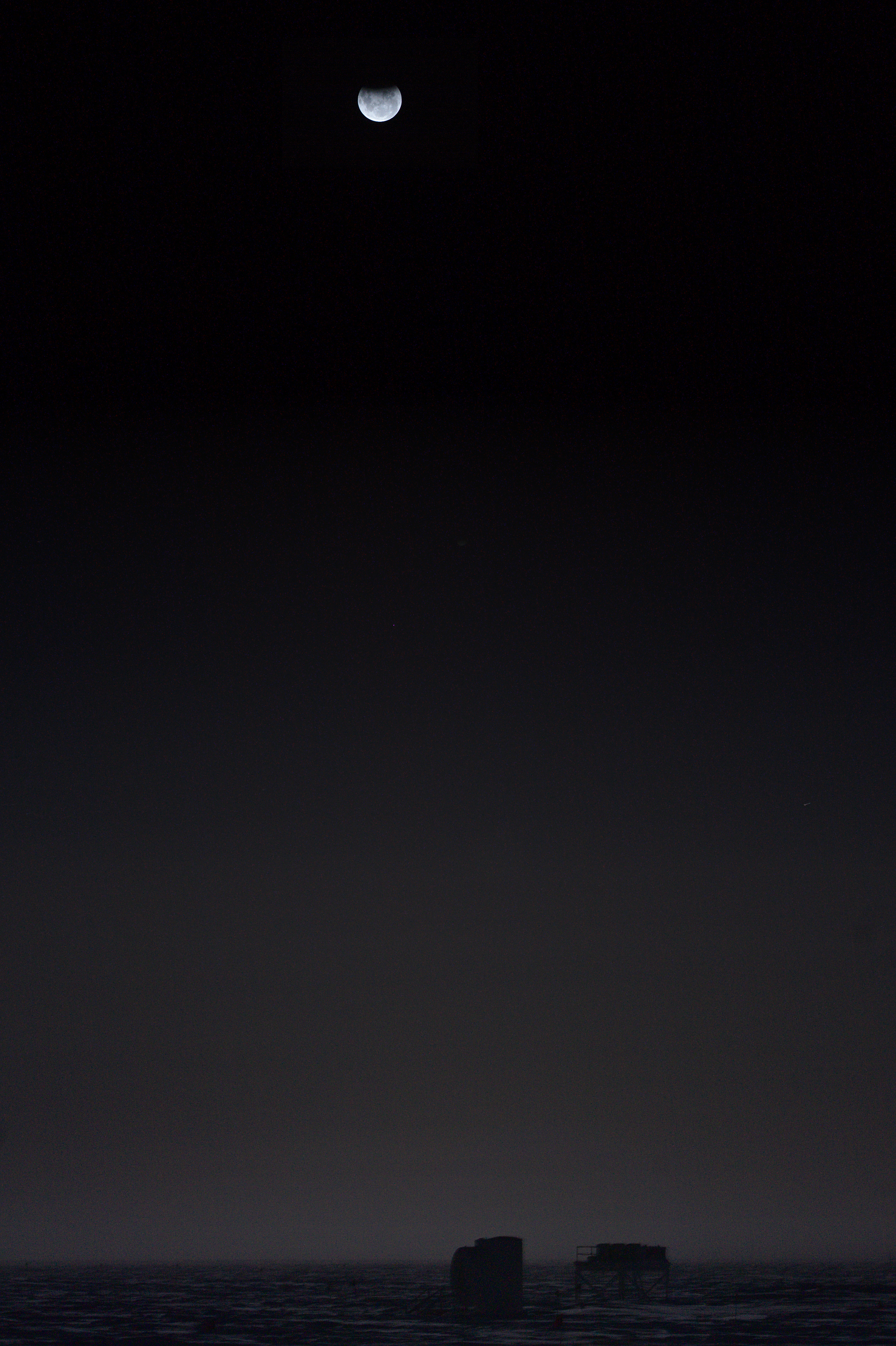 A lunar eclipse above the frosty landscape of Antarctica, early morning of August 8.